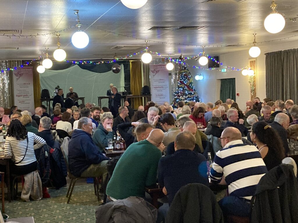 The 2023 Christmas Quiz - lots of people in a room gathered around tables